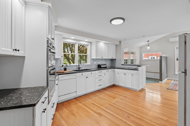 309 N Grand St, Suffield, CT 06093 - kitchen featuring a sink, white appliances, light wood-type flooring, a peninsula, and lofted ceiling