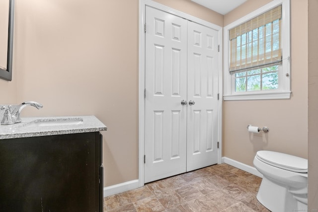 309 N Grand St, Suffield, CT 06093 - bathroom with baseboards, toilet, and vanity