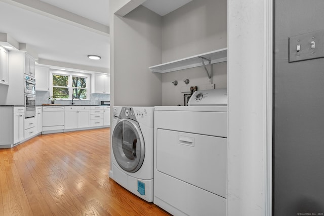 309 N Grand St, Suffield, CT 06093 - laundry room featuring washer and dryer and light wood finished floors