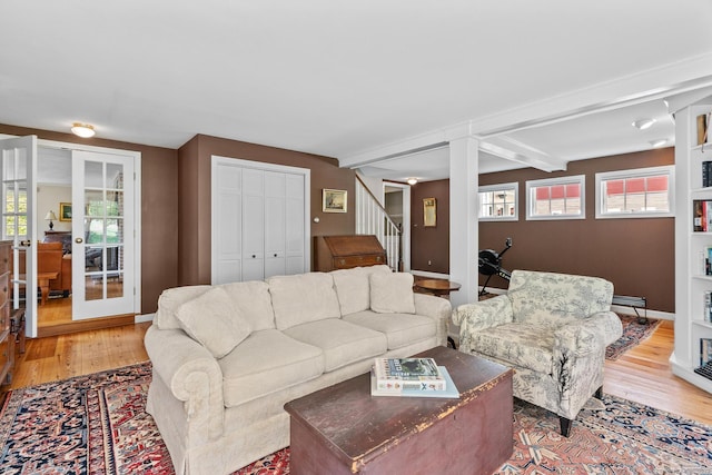 309 N Grand St, Suffield, CT 06093 - living area featuring light wood-style flooring, stairs, baseboards, french doors, and beam ceiling