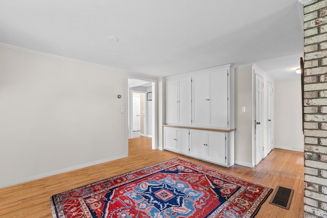 309 N Grand St, Suffield, CT 06093 - unfurnished room with light wood finished floors, baseboards, and crown molding