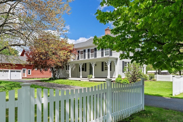 309 N Grand St, Suffield, CT 06093 - colonial inspired home featuring covered porch, asphalt driveway, a chimney, and a garage