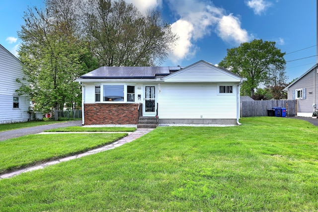 27 Aircraft Rd, West Haven, CT 06516 - view of front of house featuring roof mounted solar panels, entry steps, and brick siding