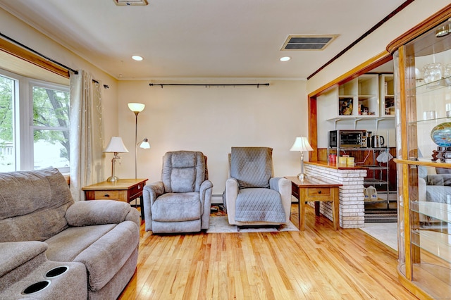 27 Aircraft Rd, West Haven, CT 06516 - living room featuring hardwood / wood-style floors, crown molding, baseboard heating, recessed lighting, and a baseboard heating unit