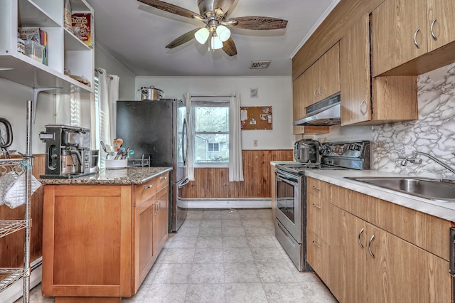 27 Aircraft Rd, West Haven, CT 06516 - kitchen with appliances with stainless steel finishes, under cabinet range hood, a sink, a wainscoted wall, and a ceiling fan