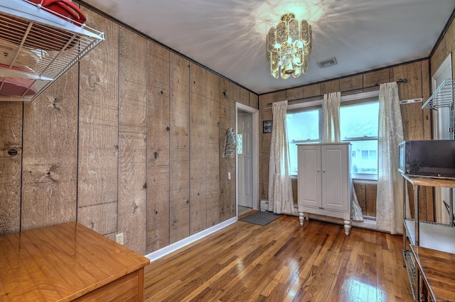 27 Aircraft Rd, West Haven, CT 06516 - entrance foyer with hardwood / wood-style flooring, wood walls, and a chandelier