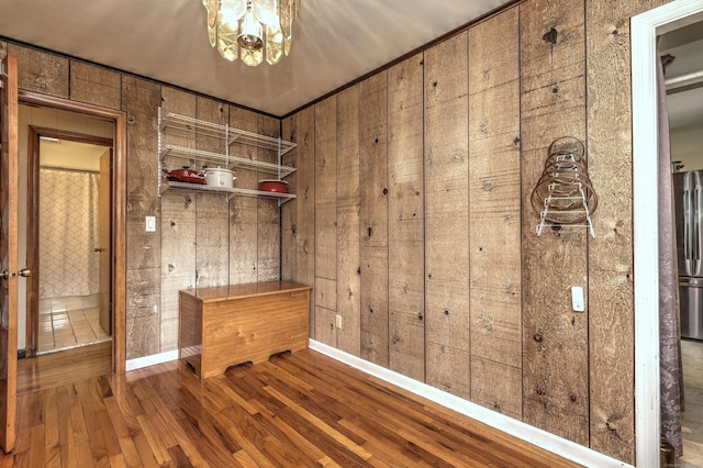 27 Aircraft Rd, West Haven, CT 06516 - mudroom with wooden walls, wood finished floors, baseboards, and a chandelier