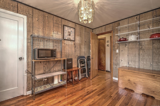 27 Aircraft Rd, West Haven, CT 06516 - living area with wood finished floors, a chandelier, and wooden walls