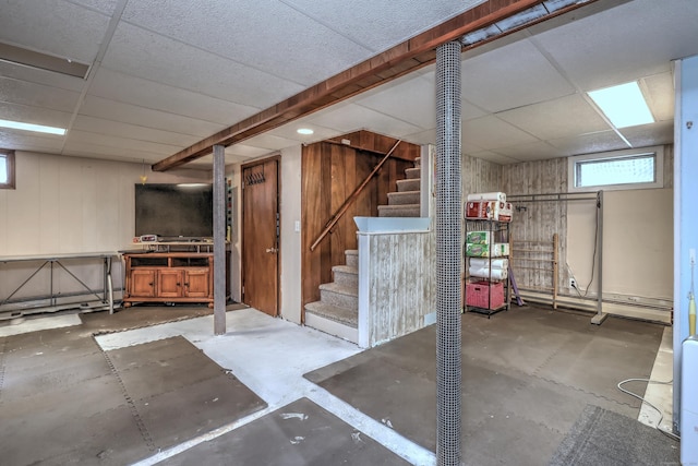 27 Aircraft Rd, West Haven, CT 06516 - below grade area featuring a drop ceiling, stairway, and a baseboard heating unit