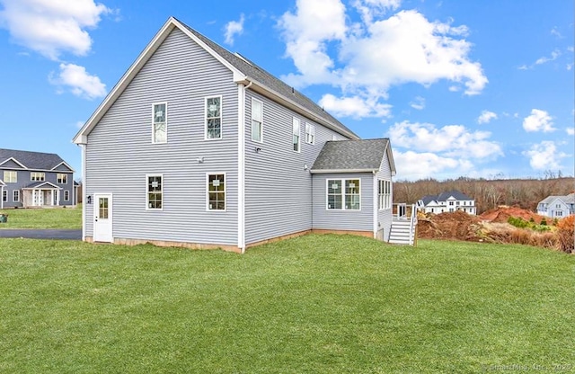 back of property with a yard