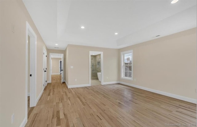 empty room with recessed lighting, baseboards, and light wood-type flooring