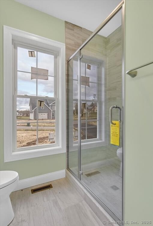full bath with visible vents, baseboards, toilet, and a shower stall