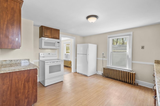 kitchen featuring radiator, white appliances, baseboards, light wood-type flooring, and light stone counters