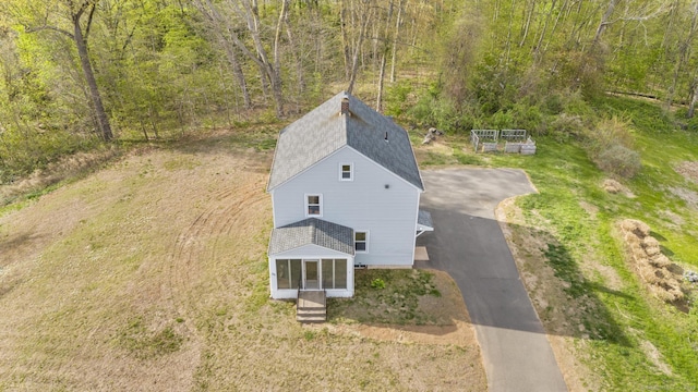 drone / aerial view featuring a forest view