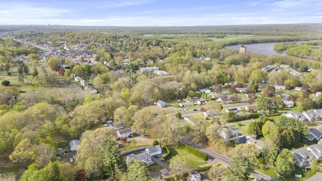 drone / aerial view with a water view and a view of trees