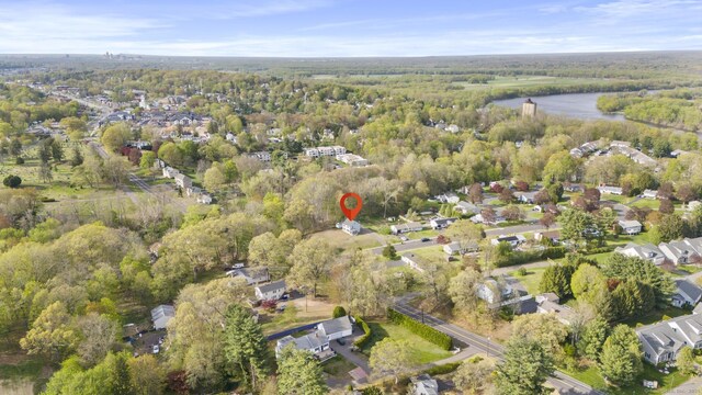 aerial view with a water view and a forest view