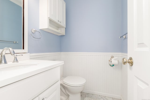 39 Wildemere Ave, Milford, CT 06460 - bathroom featuring vanity, toilet, and a wainscoted wall