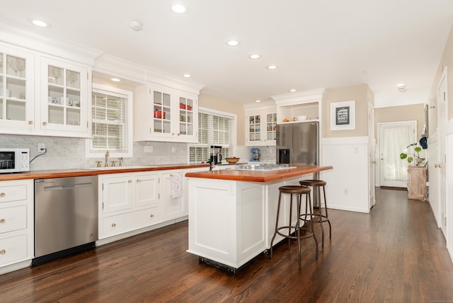 39 Wildemere Ave, Milford, CT 06460 - kitchen featuring appliances with stainless steel finishes, white cabinetry, backsplash, dark wood-style floors, and butcher block counters