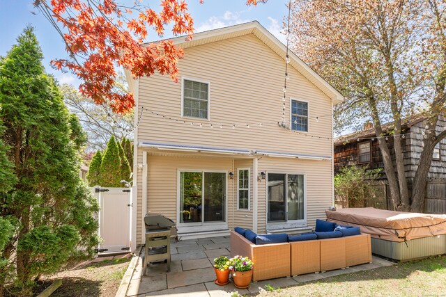 39 Wildemere Ave, Milford, CT 06460 - back of property featuring an outdoor living space, fence, a patio, and a hot tub