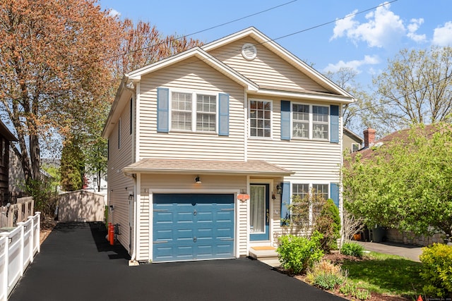 39 Wildemere Ave, Milford, CT 06460 - traditional-style house featuring a garage, fence, and aphalt driveway