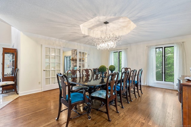 498 Eastbury Hill Rd, Glastonbury, CT 06033 - dining space featuring wood finished floors, a chandelier, crown molding, and baseboards