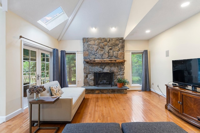 498 Eastbury Hill Rd, Glastonbury, CT 06033 - living area featuring a skylight, lofted ceiling, wood finished floors, baseboards, and a stone fireplace