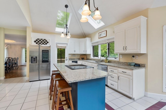 498 Eastbury Hill Rd, Glastonbury, CT 06033 - kitchen with appliances with stainless steel finishes, a skylight, a sink, light tile patterned floors, and white cabinets