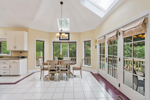 498 Eastbury Hill Rd, Glastonbury, CT 06033 - dining space with vaulted ceiling, a skylight, a chandelier, light tile patterned floors, and healthy amount of natural light
