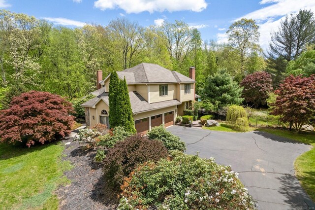 498 Eastbury Hill Rd, Glastonbury, CT 06033 - view of property exterior with a chimney, a garage, and driveway