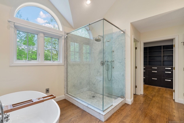 498 Eastbury Hill Rd, Glastonbury, CT 06033 - bathroom with a stall shower, vaulted ceiling, wood finished floors, a freestanding tub, and healthy amount of natural light