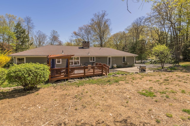 97 Doolittle Dr, Bethany, CT 06524 - back of property featuring a wooden deck, a chimney, and a patio