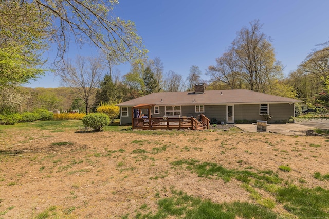 97 Doolittle Dr, Bethany, CT 06524 - back of house featuring a patio, a wooden deck, and a chimney