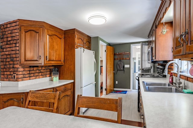 97 Doolittle Dr, Bethany, CT 06524 - kitchen with brown cabinets, a sink, light countertops, range with electric cooktop, and freestanding refrigerator