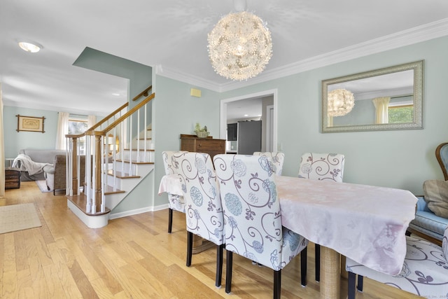 200 Sachem Head Rd, Guilford, CT 06437 - dining space with stairs, a chandelier, crown molding, wood finished floors, and baseboards