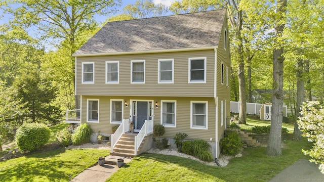 200 Sachem Head Rd, Guilford, CT 06437 - view of front of property featuring a front yard, a storage shed, an outdoor structure, and roof with shingles
