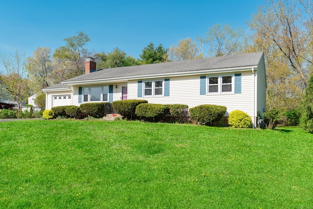 single story home with a chimney, an attached garage, and a front lawn