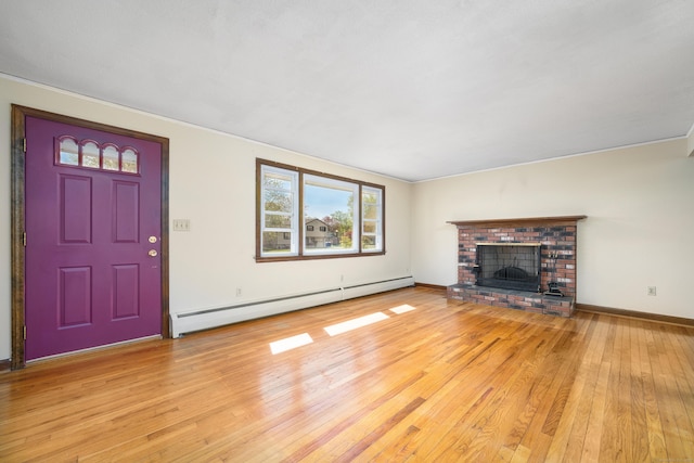 unfurnished living room with a baseboard heating unit, light wood-style flooring, a fireplace, and baseboards
