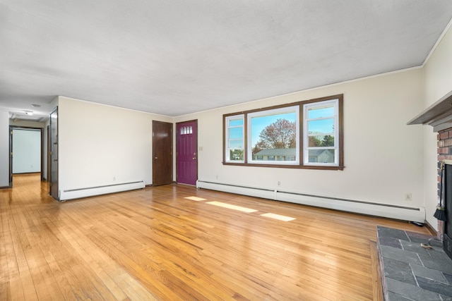 unfurnished living room with a baseboard heating unit, baseboard heating, light wood-type flooring, and a fireplace