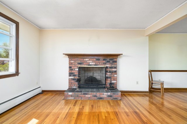 unfurnished living room featuring baseboard heating, wood finished floors, crown molding, a brick fireplace, and baseboards