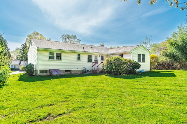 back of property featuring a lawn and a chimney