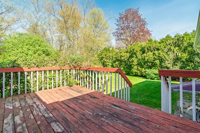 wooden terrace featuring a yard