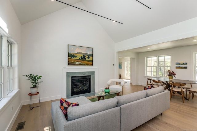 24 Tompkins Hill Rd, Washington, CT 06793 - living room with high vaulted ceiling, a fireplace with flush hearth, light wood-style flooring, baseboards, and recessed lighting