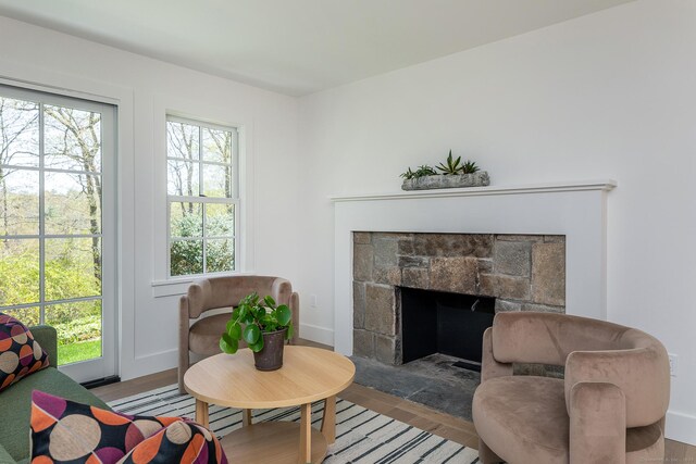 24 Tompkins Hill Rd, Washington, CT 06793 - living room with wood finished floors, a stone fireplace, and baseboards