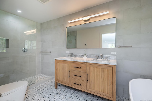 24 Tompkins Hill Rd, Washington, CT 06793 - full bathroom featuring tile walls, double vanity, a walk in shower, a soaking tub, and toilet