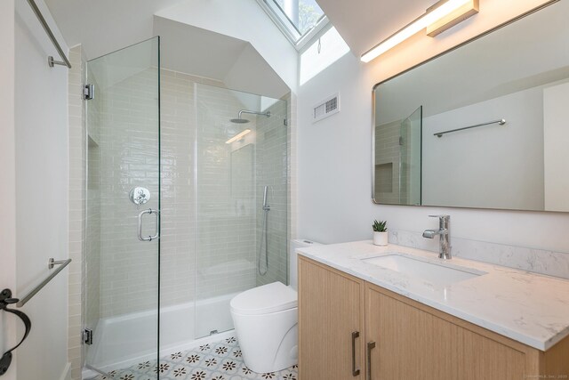 24 Tompkins Hill Rd, Washington, CT 06793 - full bath featuring a skylight, vanity, toilet, a shower stall, and tile patterned floors