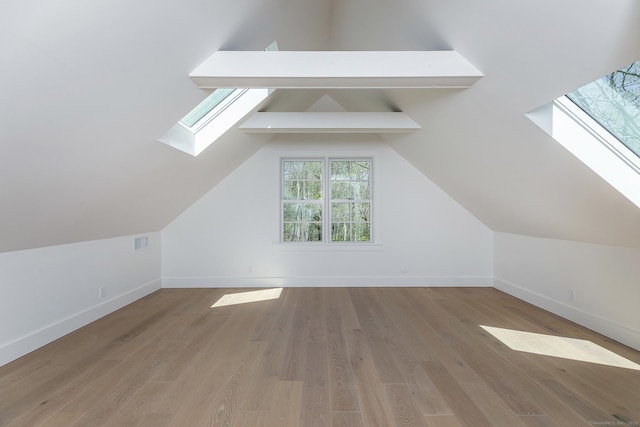 24 Tompkins Hill Rd, Washington, CT 06793 - additional living space with a skylight, baseboards, wood finished floors, and vaulted ceiling