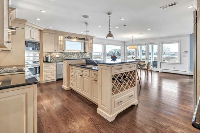 29 Covelee Dr, Norwalk, CT 06855 - kitchen featuring cream cabinetry, appliances with stainless steel finishes, dark countertops, and recessed lighting