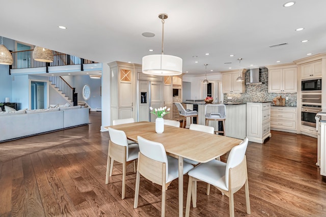 dining area featuring recessed lighting, visible vents, wood finished floors, and stairway