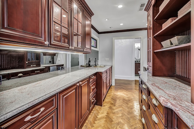 kitchen with open shelves, light stone countertops, baseboards, glass insert cabinets, and ornamental molding