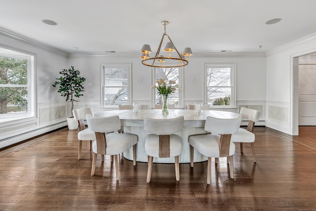 dining area with baseboard heating, an inviting chandelier, a healthy amount of sunlight, and a decorative wall